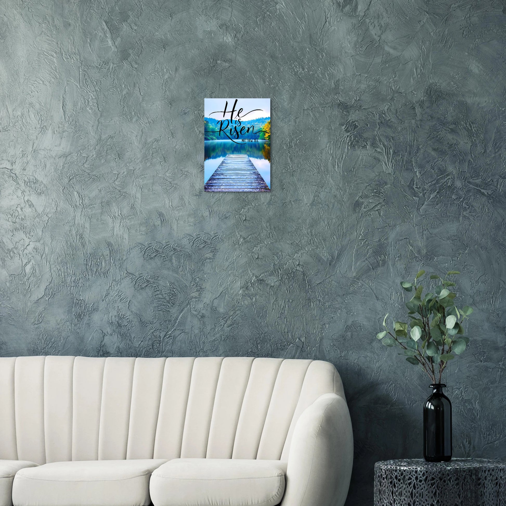 Wall art with a scenic view of a lake and text on a gray wall above a beige sofa.