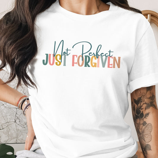 White t-shirt with 'Not Perfect Just Forgiven' text worn by a person.