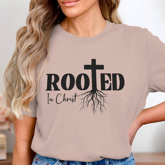 Beige t-shirt with 'Rooted In Christ' design worn by a person.